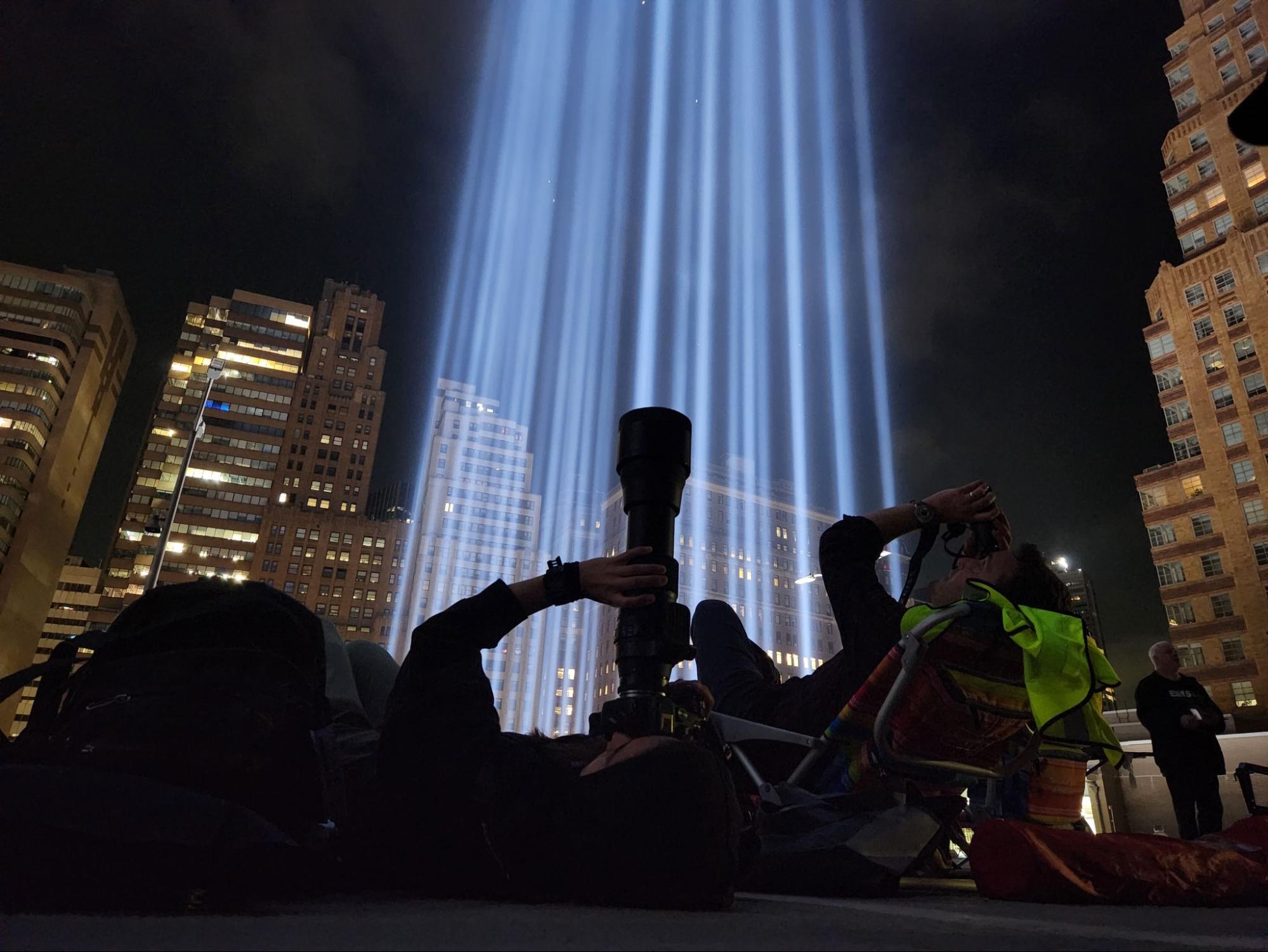 NYC Bird Alliance scientists observe the southern Tribute in Light beam through a camera scope and binoculars. © NYC Bird Alliance